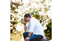 Image Sad man sitting in the woods thinking about life